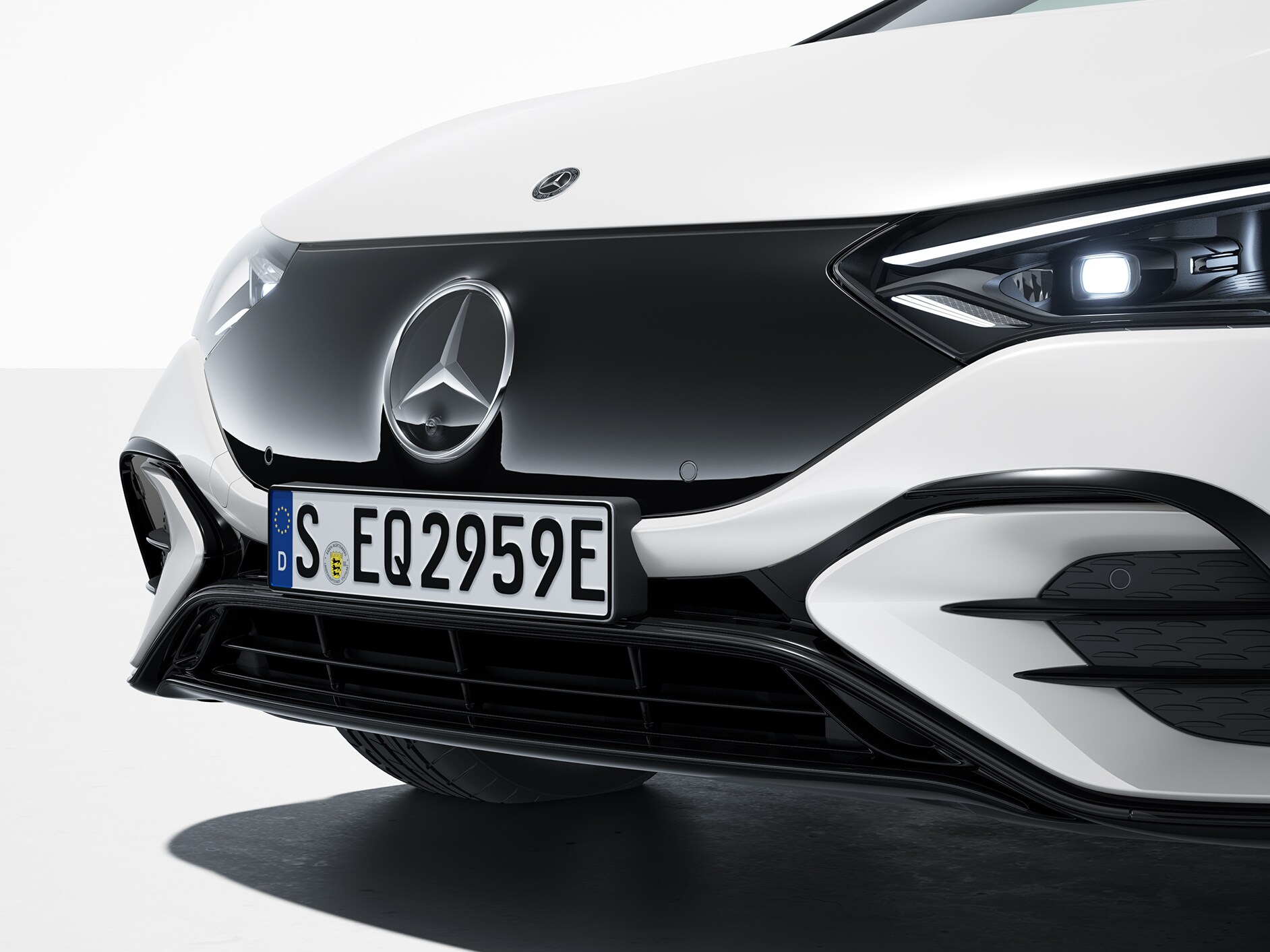 The EQE Saloon by Mercedes-EQ from a frontal side view.