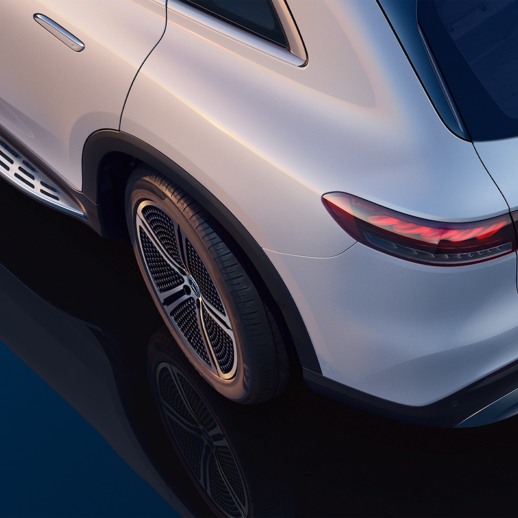 Shot from above, showing the left rear section of the EQS SUV and a slightly turned rear wheel.