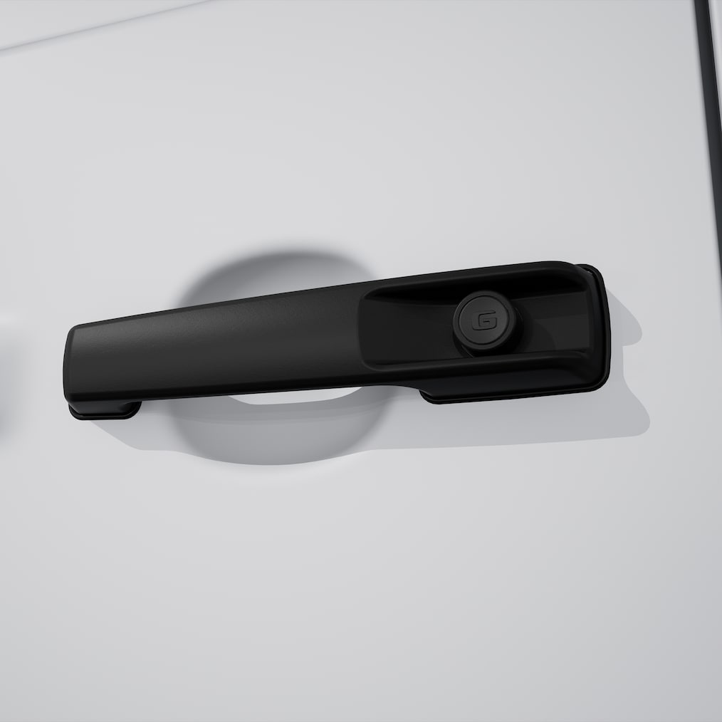 Close-up on a MANUFAKTUR door knob in black with embossed logo.