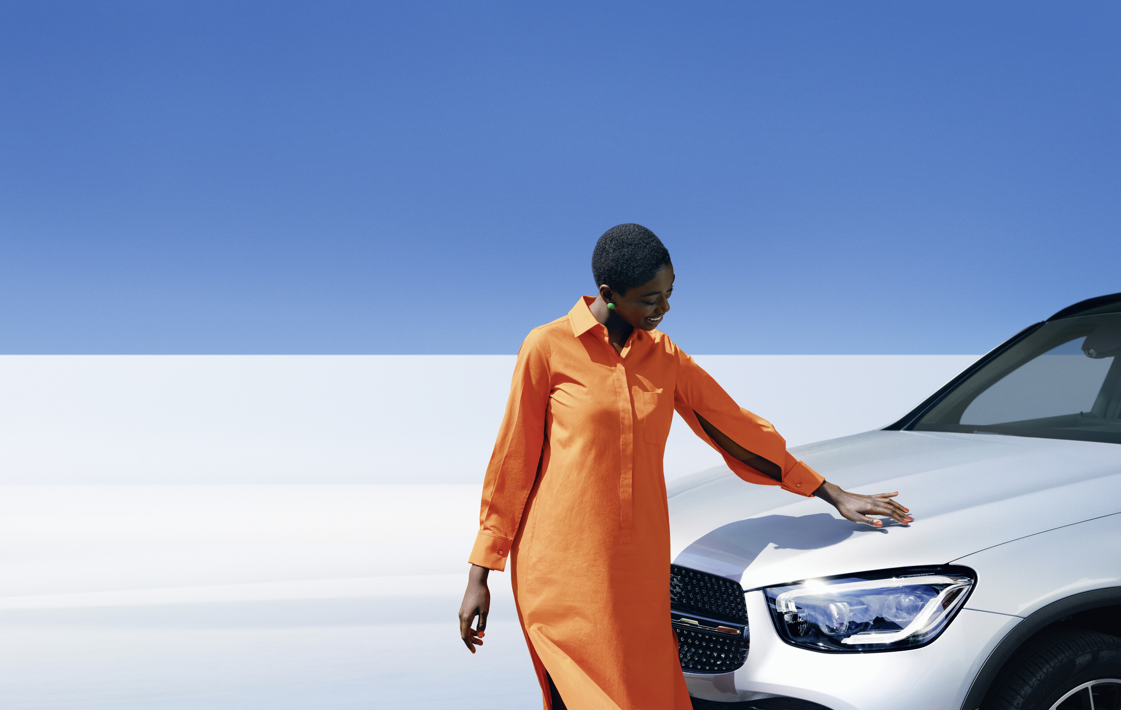 Mercedes-Benz | Genuine Car Care Products A woman inspecting her Mercedes-Benz