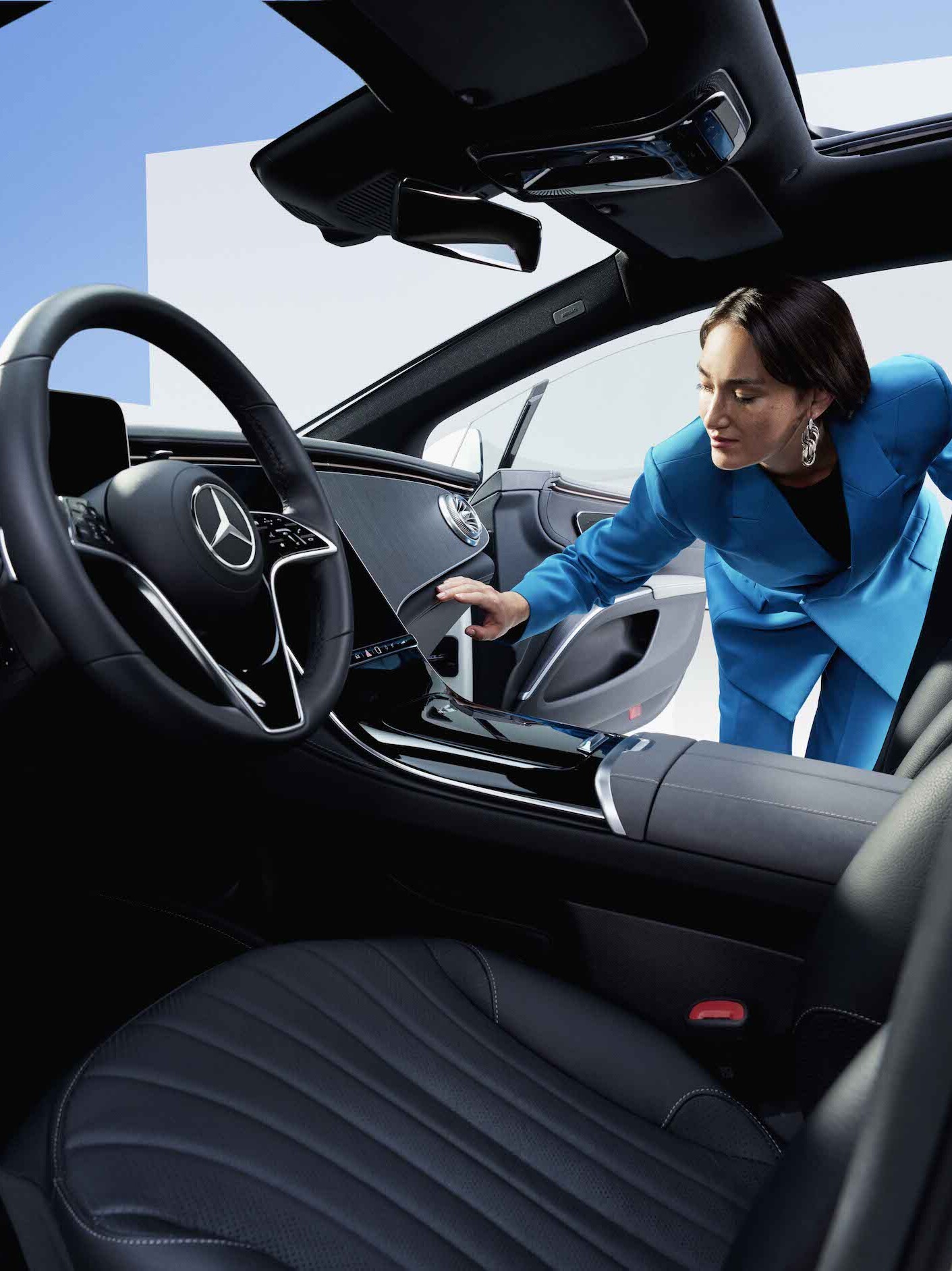 A woman inspects the clean vehicle interior of a Mercedes-Benz.