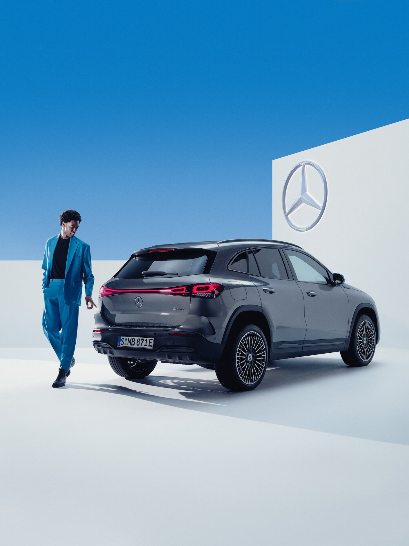 A man walks alongside his Mercedes-Benz.