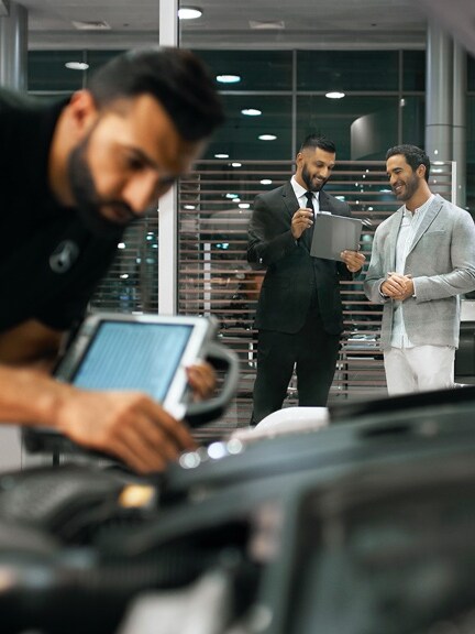 A Mercedes-Benz technician checks the vehicle's electrical system battery.