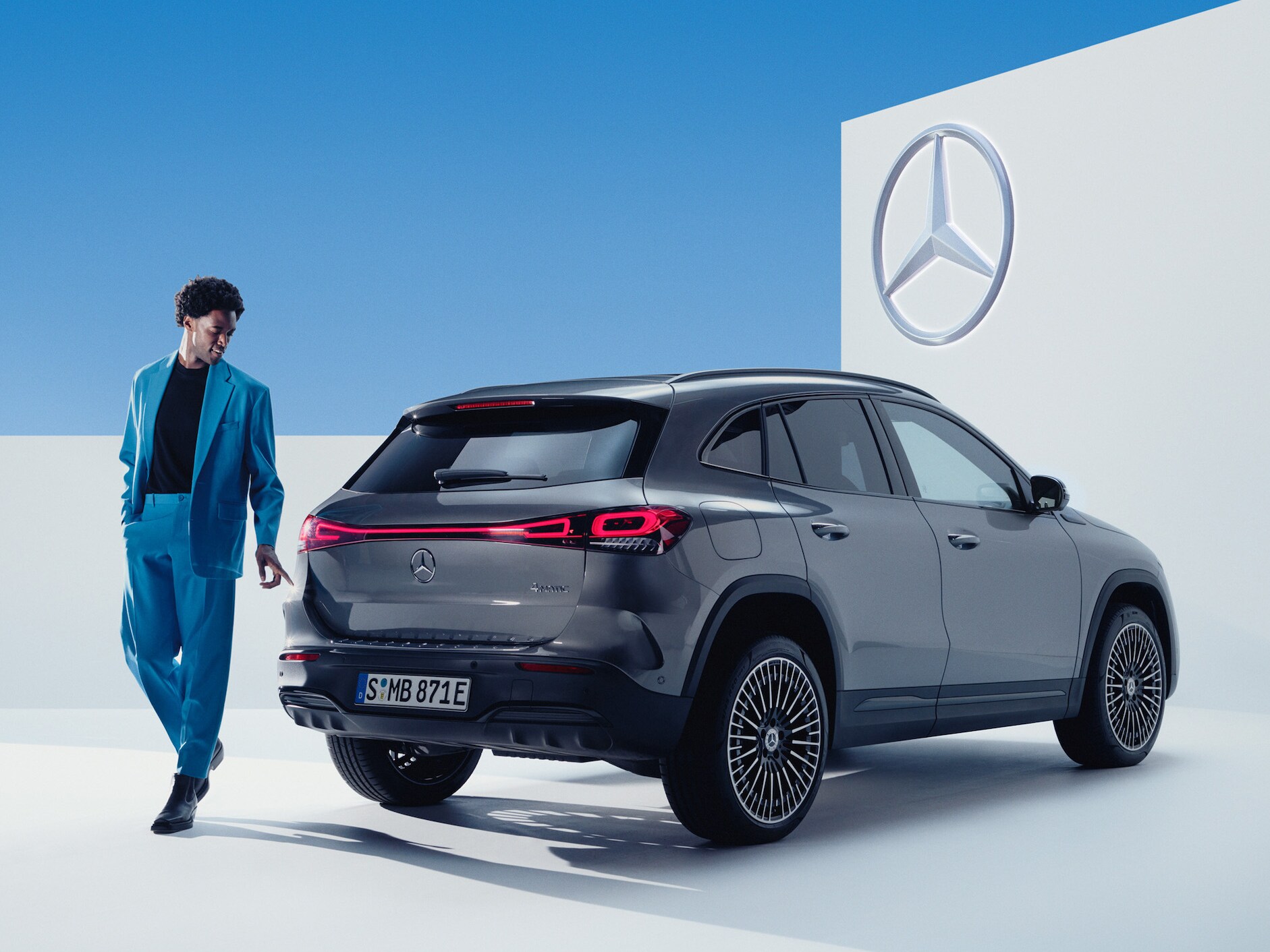 A man looks at his Mercedes-Benz.